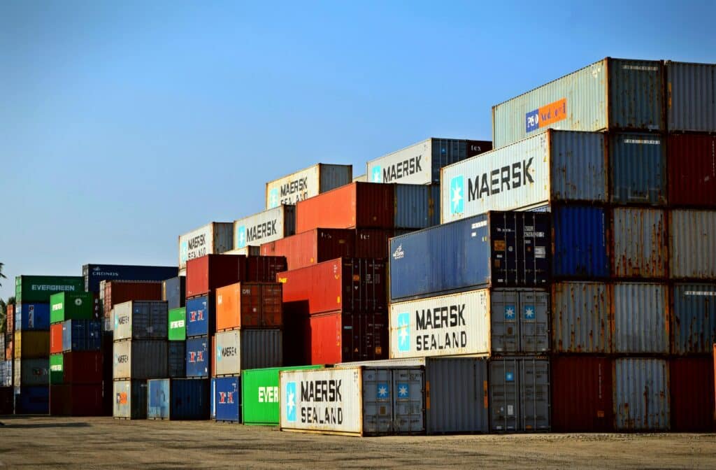 Kolorowe kontenery transportowe w porcie są przykładem globalnej logistyki.